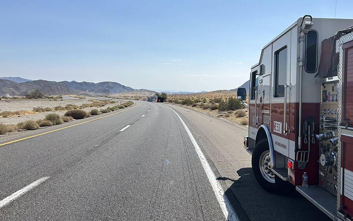 A San Bernardino County Fire crew keeps its distance from a burning truck carrying lithium ion ...
