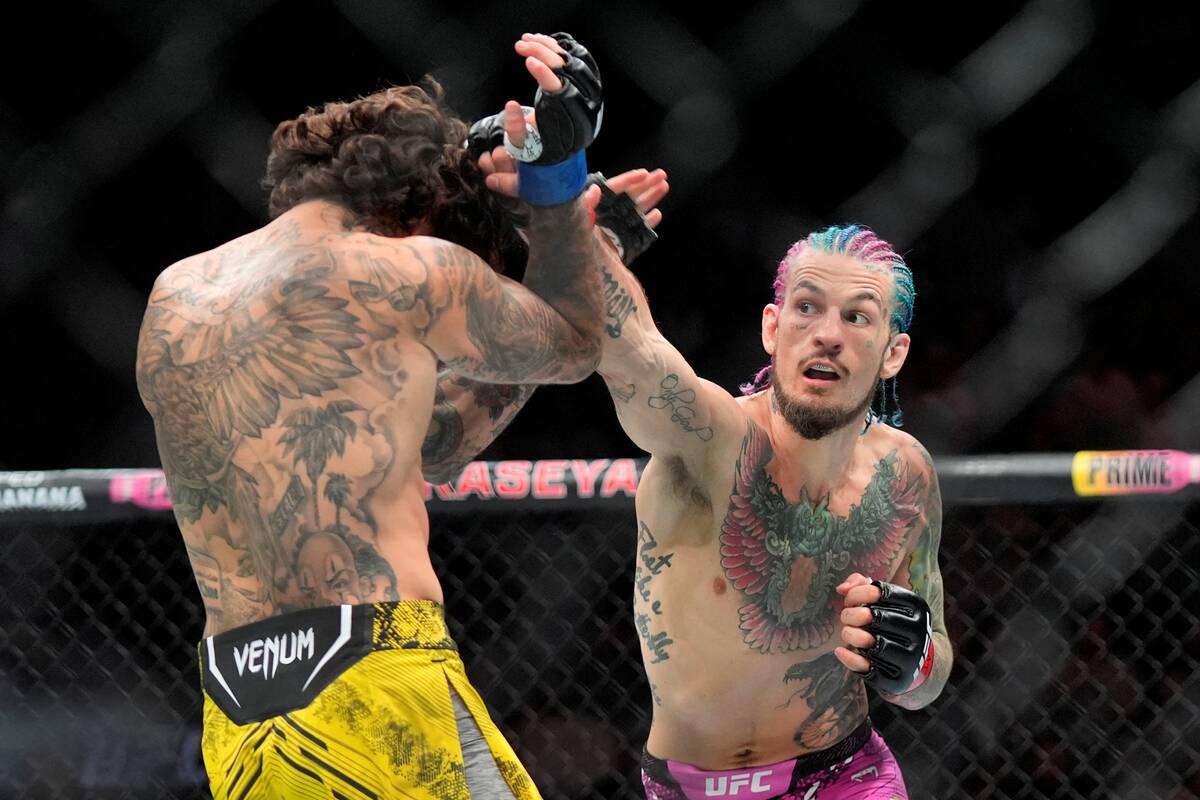 Sean O'Malley hits Marlon Vera during a bantamweight title bout at the UFC 299 mixed martial ar ...