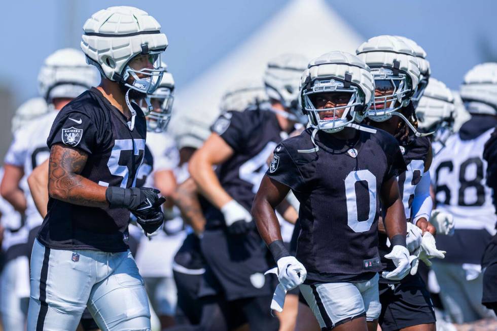 Raiders defensive end TJ Franklin (57) and cornerback Jakorian Bennett (0) run to new spots for ...