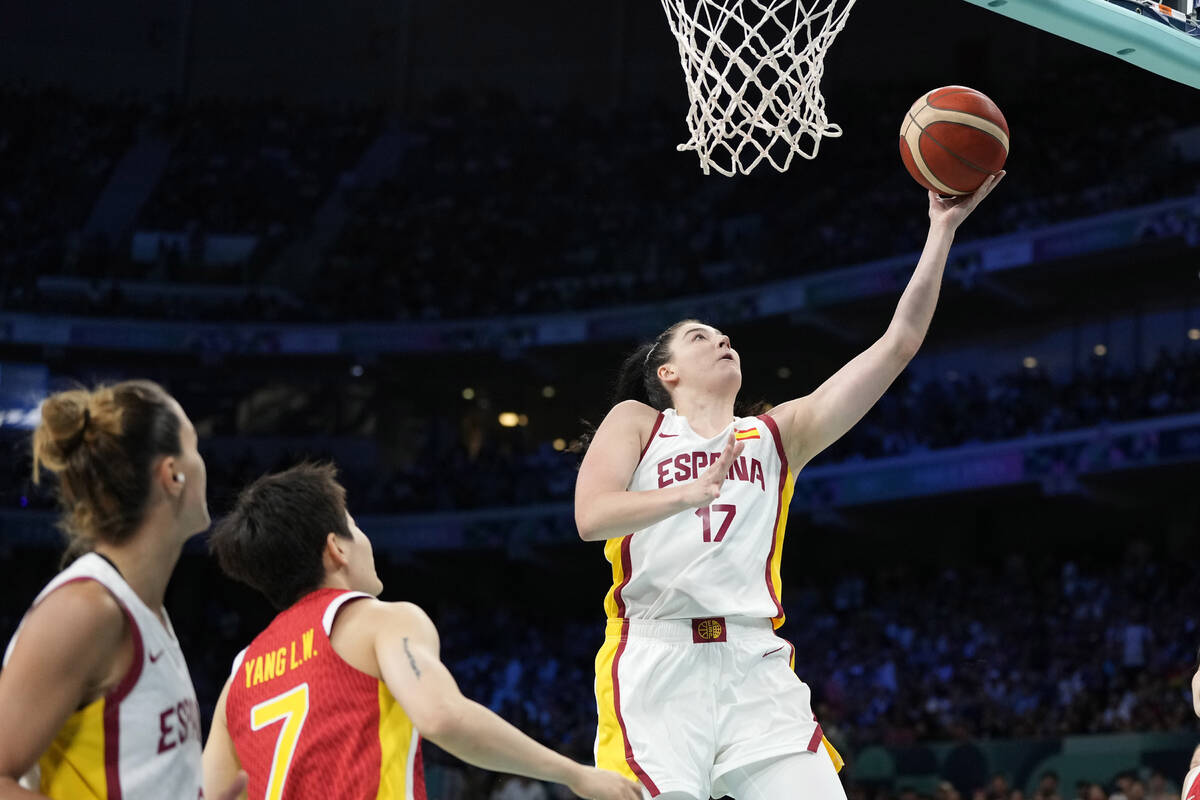 Megan Gustafson, right, of Spain, shoots as Liewi Yang, of China, watches in a women's basketba ...