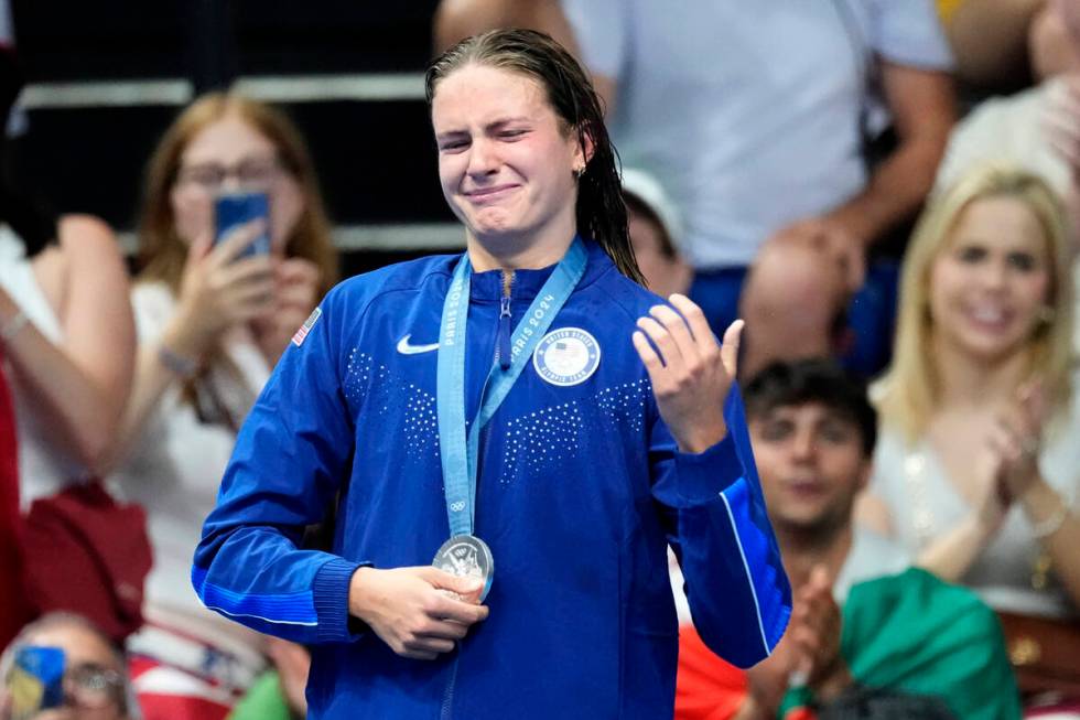 Silver medalist Katie Grimes, of the United States, reacts on the podium following the women's ...