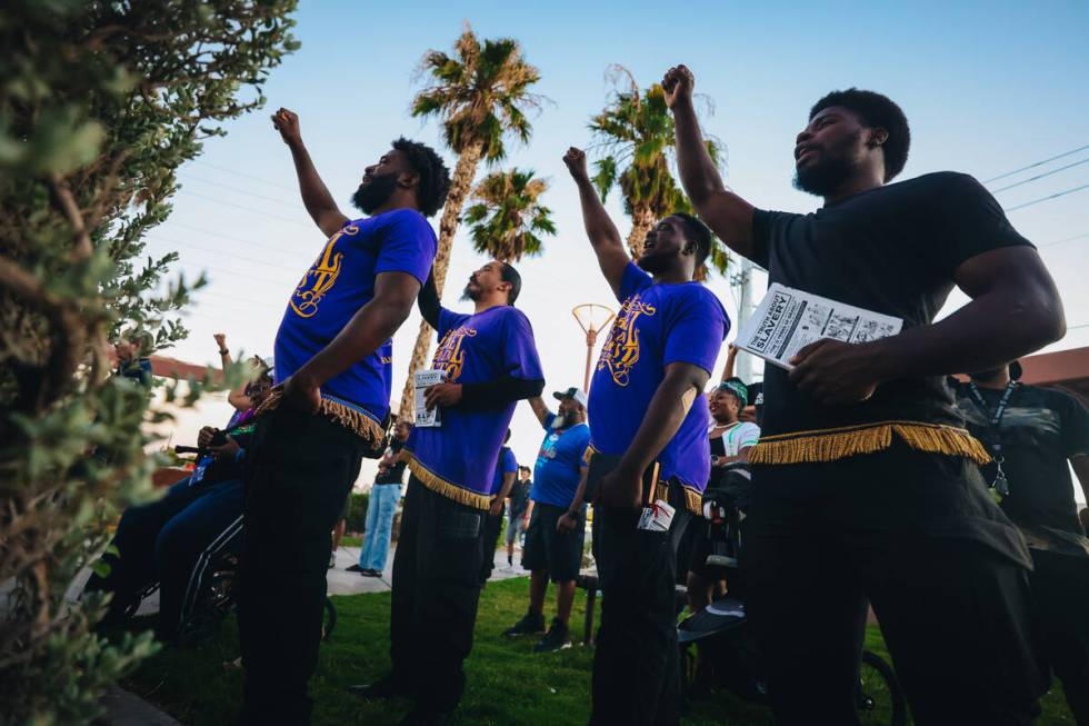 Mourners raise their fists during a vigil for Sonya Massey, a Black woman who was killed in her ...