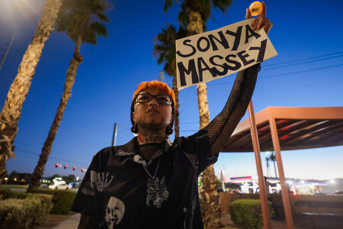 A mourner holds up a sign with Sonya Massey’s name on it during a vigil for Sonya Massey ...