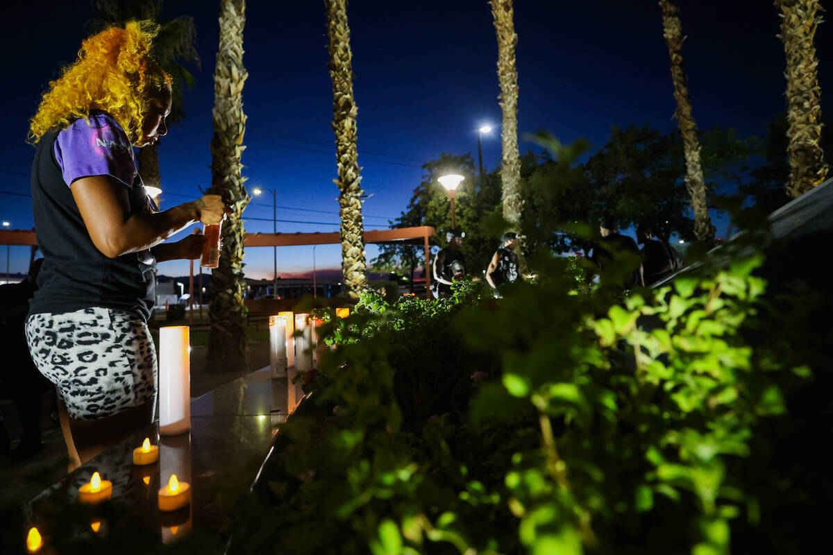 A mourner lights a candle during a vigil for Sonya Massey, a Black woman who was killed in her ...