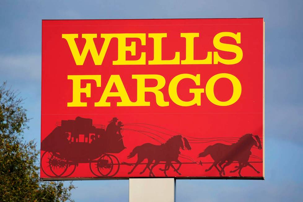 FILE - A Wells Fargo sign stands in front of a branch of the bank in Bradenton, Fla., Tuesday, ...