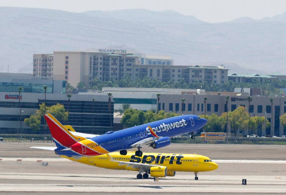 A Southwest Airlines jet takes off as a Spirit Airlines jet taxis at Harry Reid International A ...