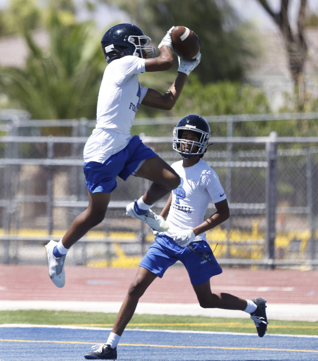 Desert Pines cornerback Jonathan Miller intercepts the ball during the first day of high school ...