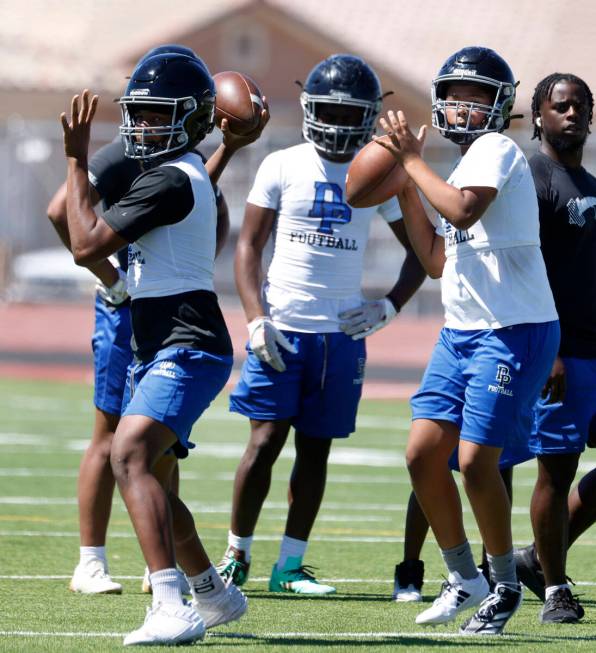 Desert Pines quarterbacks Keyshawn Martin, left, and Mason McCrary prepare to throw the ball du ...