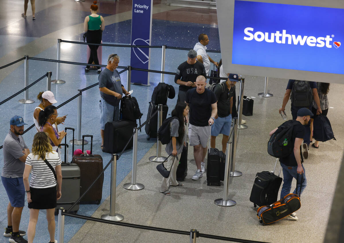 Travelers line up to check in at Southwest ticket counter at Harry Reid International Airport o ...