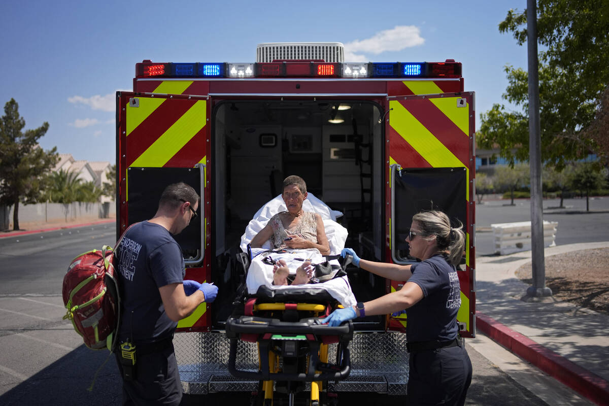 Members of the Henderson Fire Department load Deb Billet, 66, into an ambulance before transpor ...