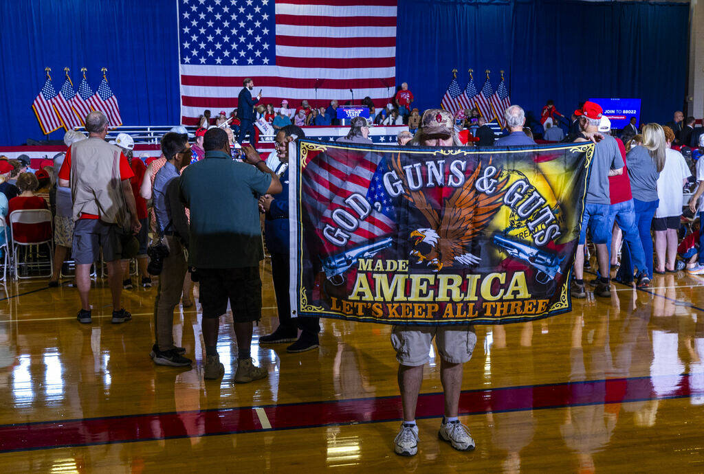 A supporter unfurls his banner for all to see in the gym before Ohio Senator JD Vance delivers ...