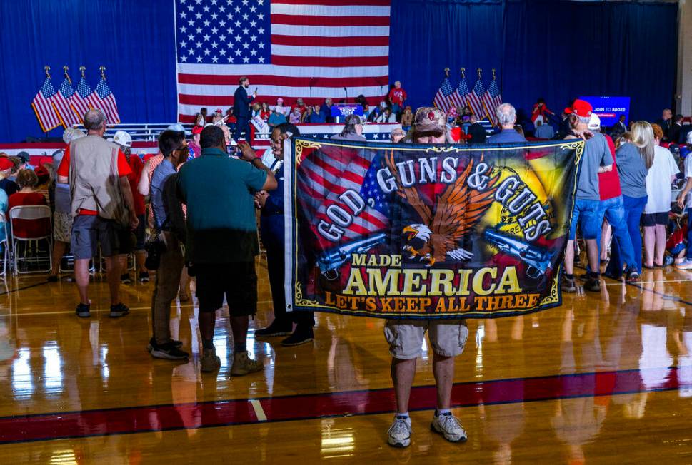 A supporter unfurls his banner for all to see in the gym before Ohio Senator JD Vance delivers ...