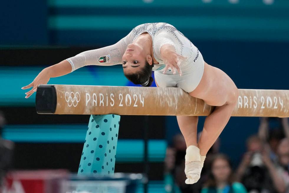 Manila Esposito, of Italy, performs on the balance beam during the women's artistic gymnastics ...