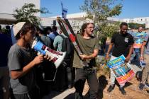 Right-wing Israelis, one holding a Palestinian scarf, at a protest outside of the initial heari ...