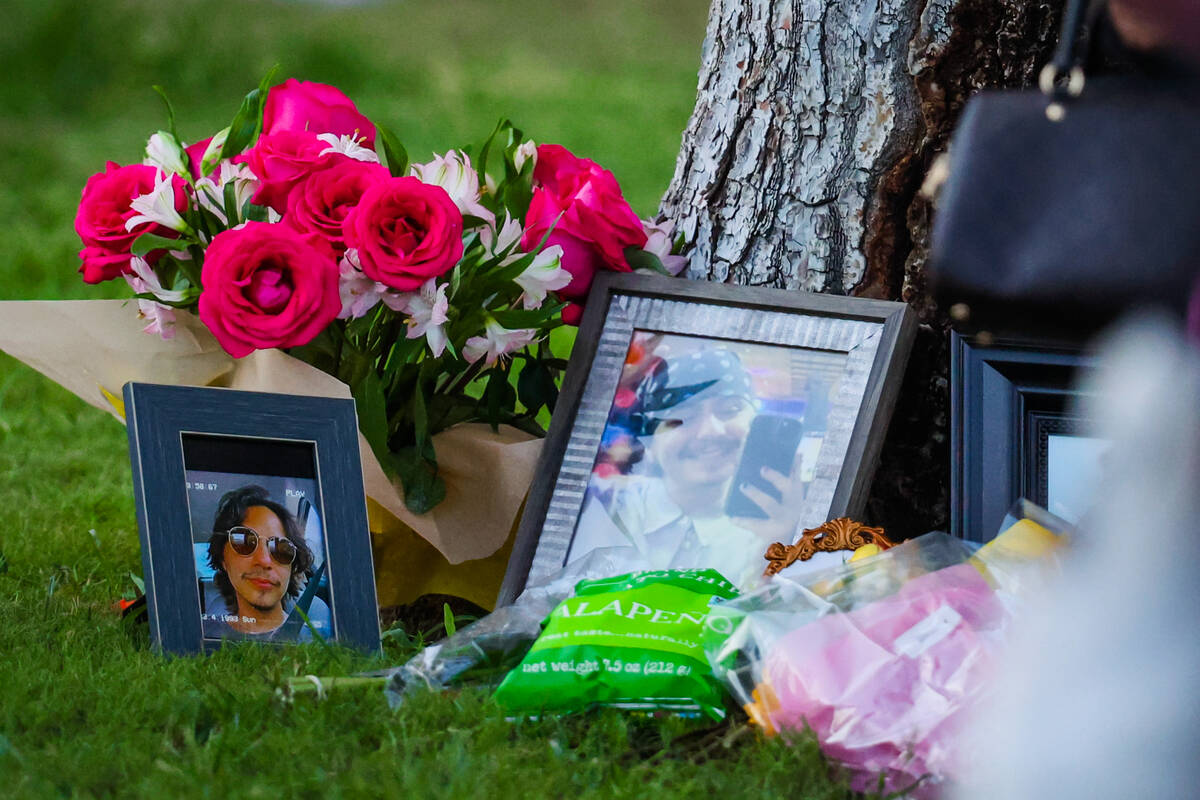 Flowers, photographs and other tributes are laid out during a vigil for Kameron Moore and Vince ...