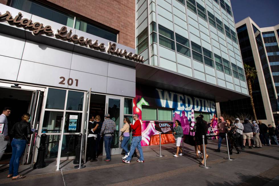 People wait in line at the Clark County Marriage License Bureau on Monday, Feb. 21, 2022, in La ...