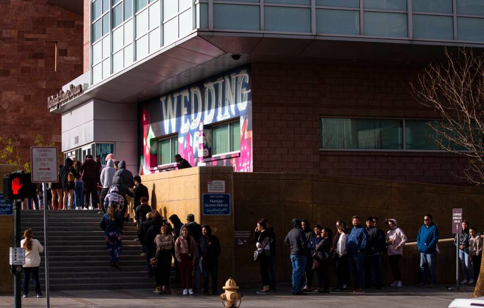 People wait in line at the Clark County Marriage License Bureau on Monday, Feb. 21, 2022, in La ...