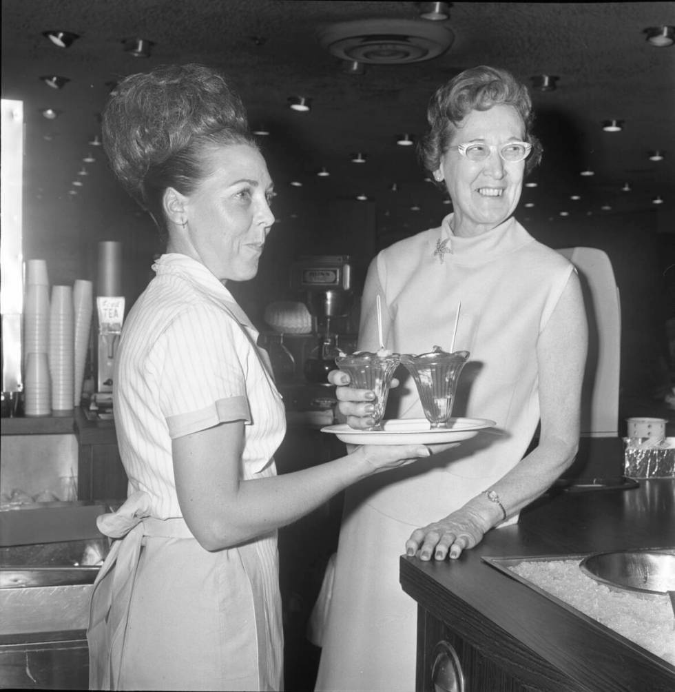 Waitress Gladys Reed brings a pair of 99-cent shrimp cocktails to Johnnie Wilson in an undated ...