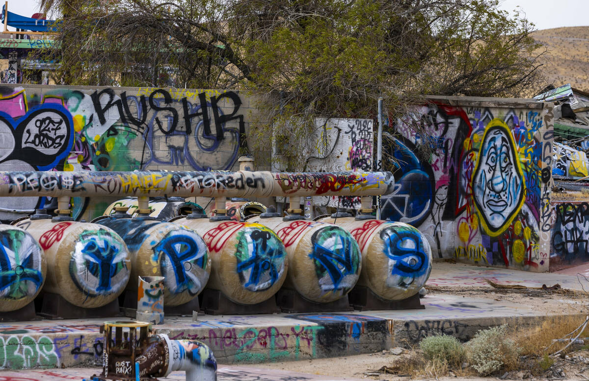 Tanks and building exteriors are covered in graffiti at the former Rock-A-Hoola Water Park on T ...