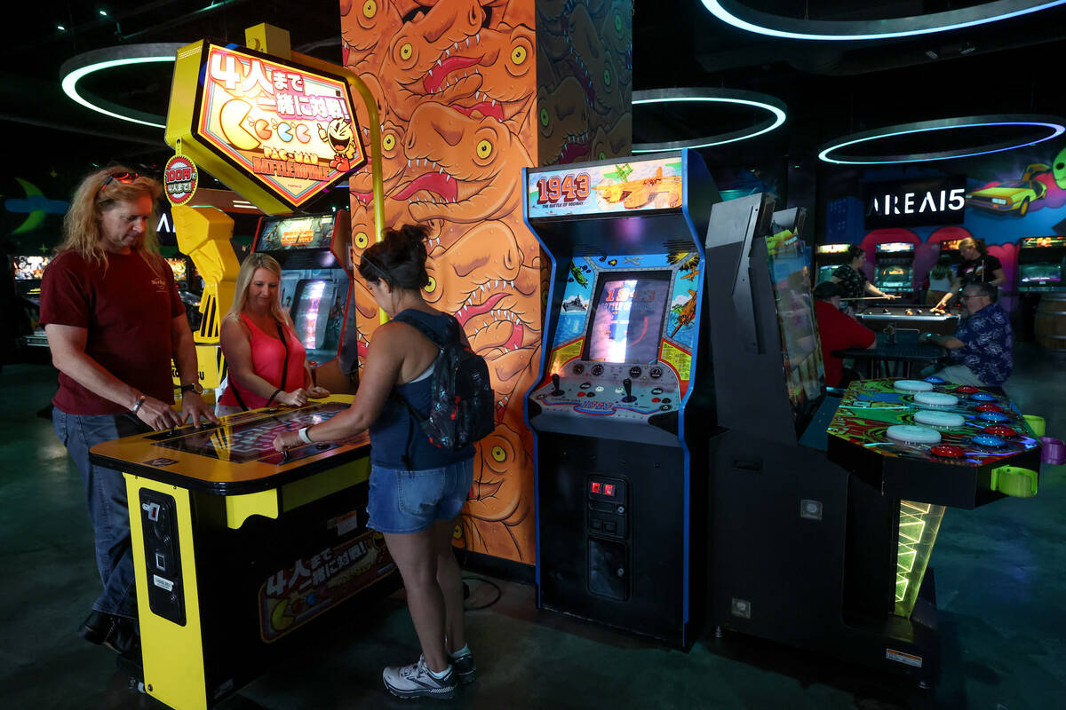 Visitors to Area 15 play games at Asylum Arcade and Bar on Thursday, July 11, 2024, in Las Vega ...