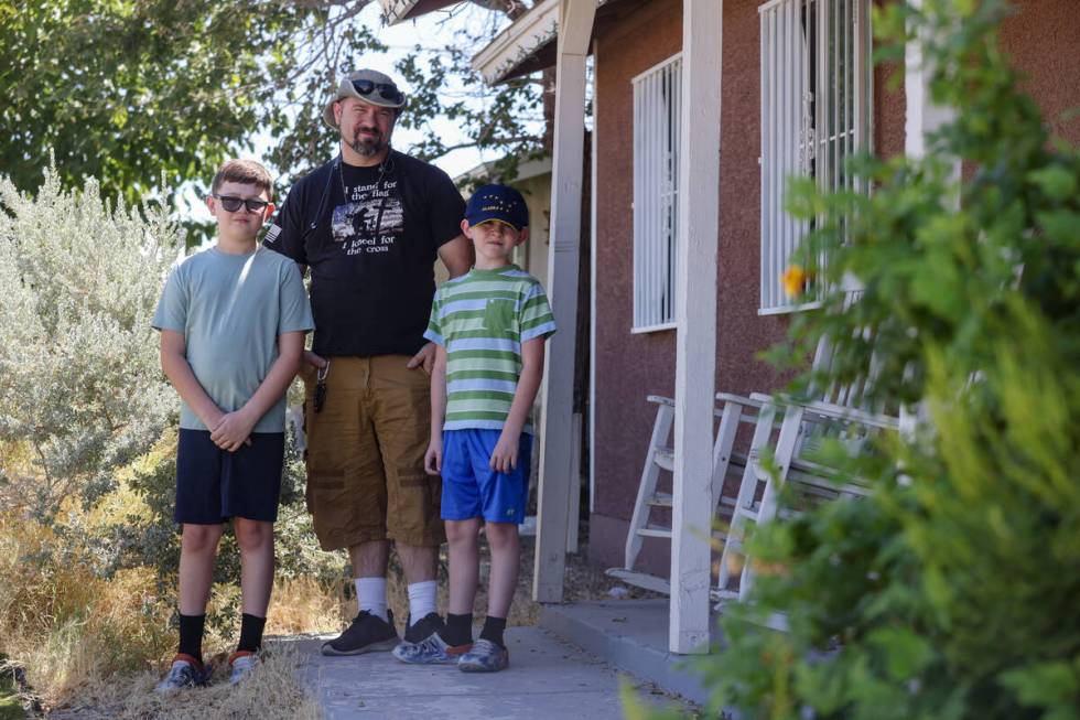 Local resident Jason Smith poses for a portrait with his children Wesson Smith, 11, left, and D ...