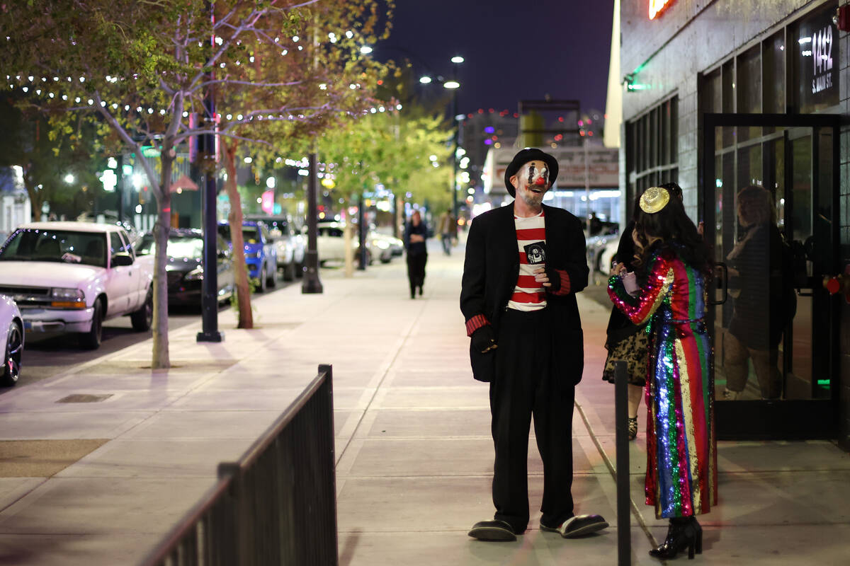 Clowns take a smoke break on Main Street during First Friday on Friday, April 5, 2024, in downt ...