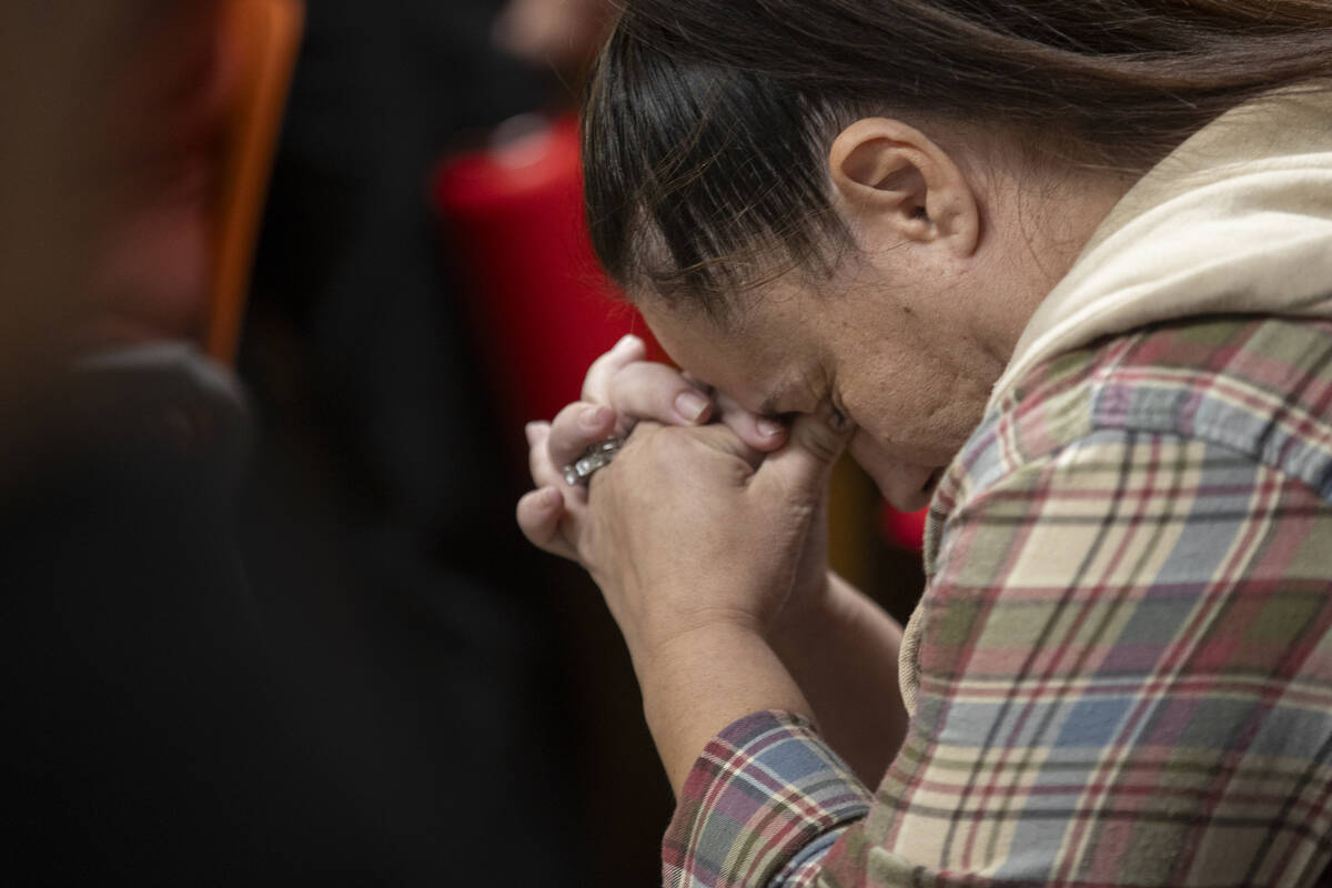 Monique Sweeney, the mother of a Lundy Elementary student, places her head in her hands after s ...