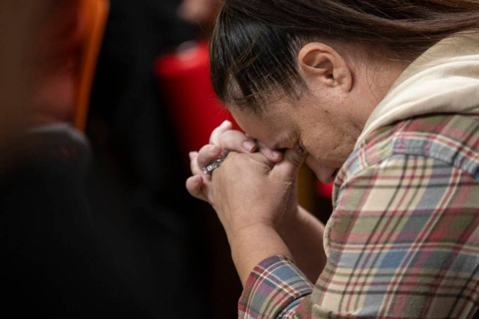 Monique Sweeney, the mother of a Lundy Elementary student, places her head in her hands after s ...