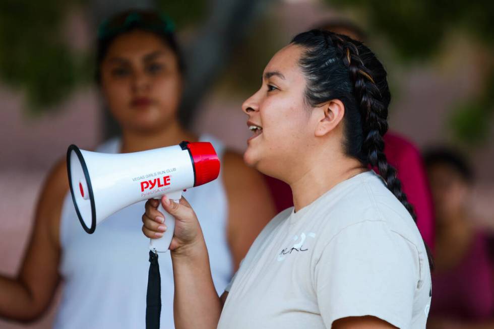 Maria Muñoz, a fitness trainer, speaks to runners about warmups during a Las Vegas Girls R ...