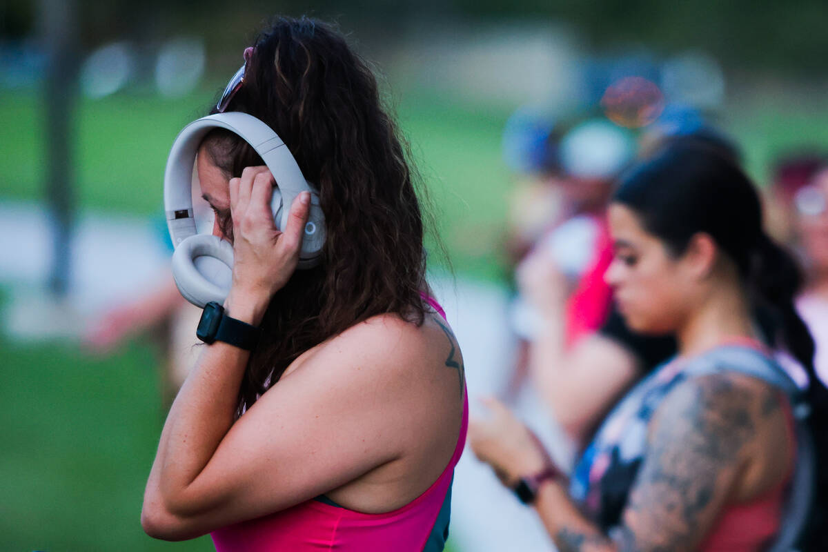 Runners get their music ready for a run with the Las Vegas Girls Run Club at Seastrand Park on ...