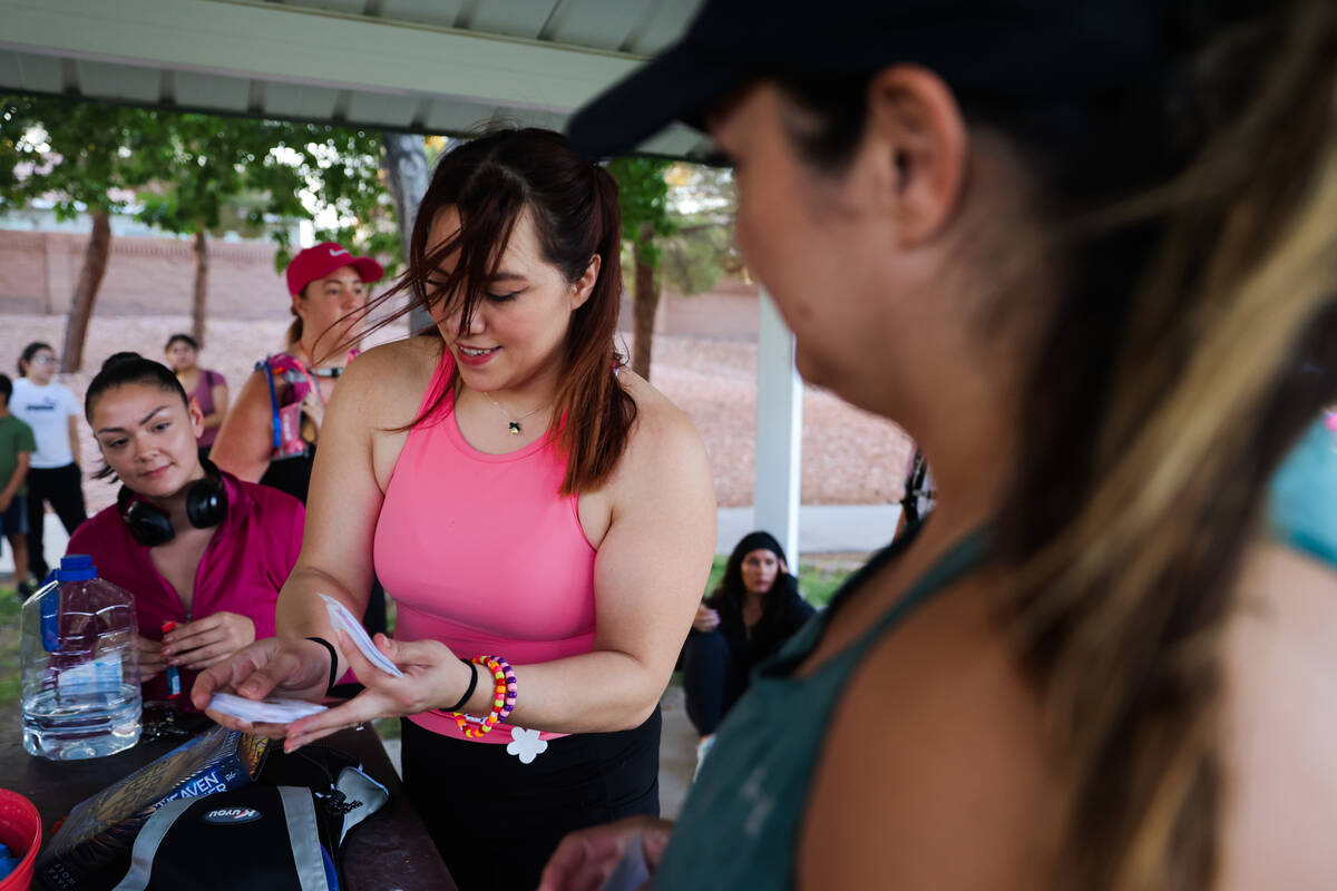 Michelle Way, the founder of Las Vegas Girls Run Club, hands out stickers during a Las Vegas Gi ...