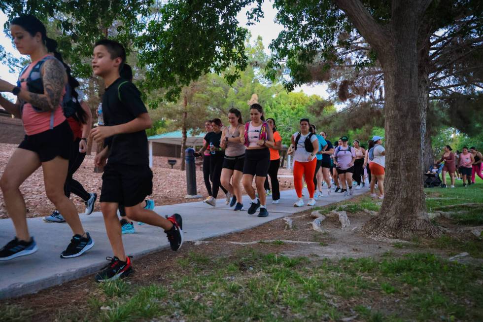 Runners begin taking to their routes during a Las Vegas Girls Run Club meeting at Seastrand Par ...