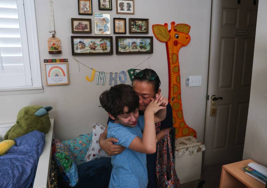 Caroline Ver, a registered behavior technician, greets Jakob Velez, 8, at his home in Las Vegas ...