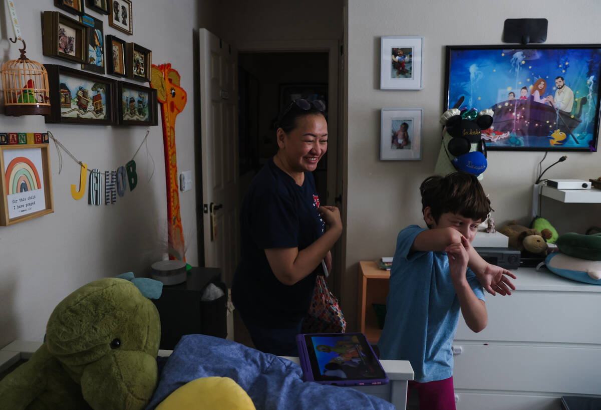 Caroline Ver, a registered behavior technician, greets Jakob Velez, 8, at his home in Las Vegas ...