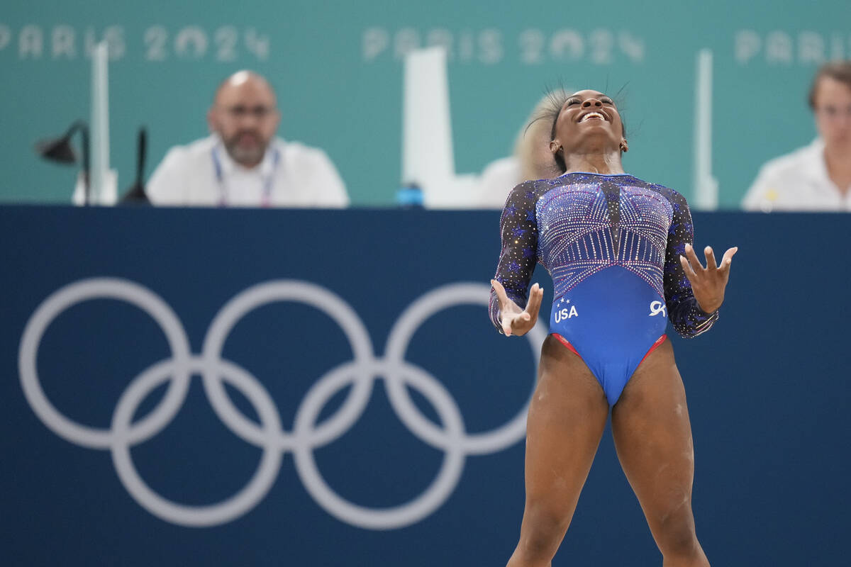 Simone Biles, of the United States, performs on the floor during the women's artistic gymnastic ...