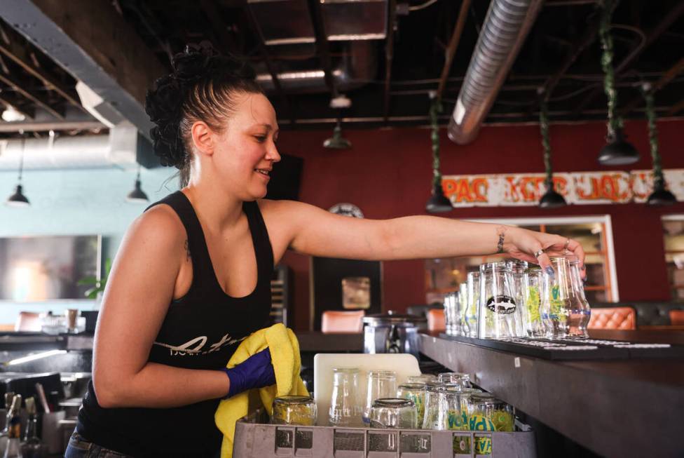 Bartender Athena Young cleans glasses while speaking to the Review-Journal about the “no tax ...