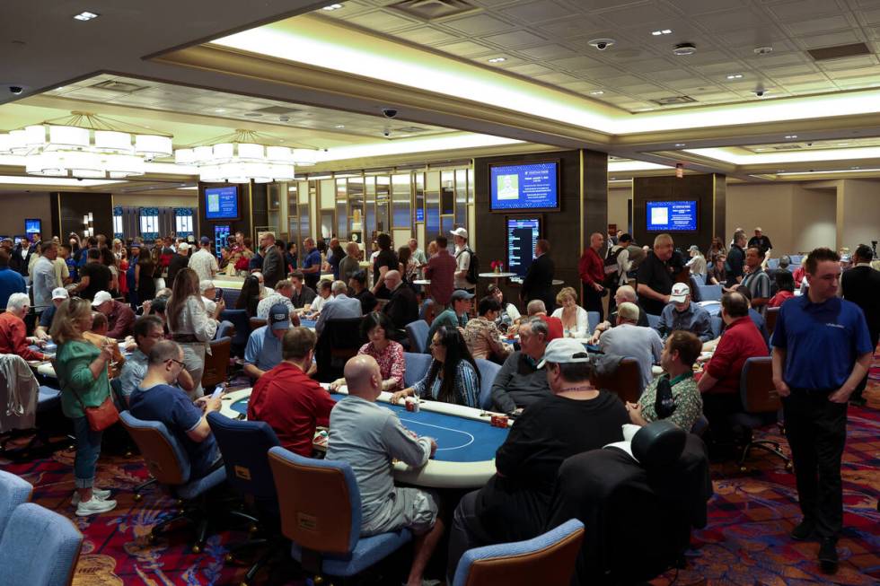 Players take to the tables during an opening event for a new poker room in the Grand Canal Shop ...