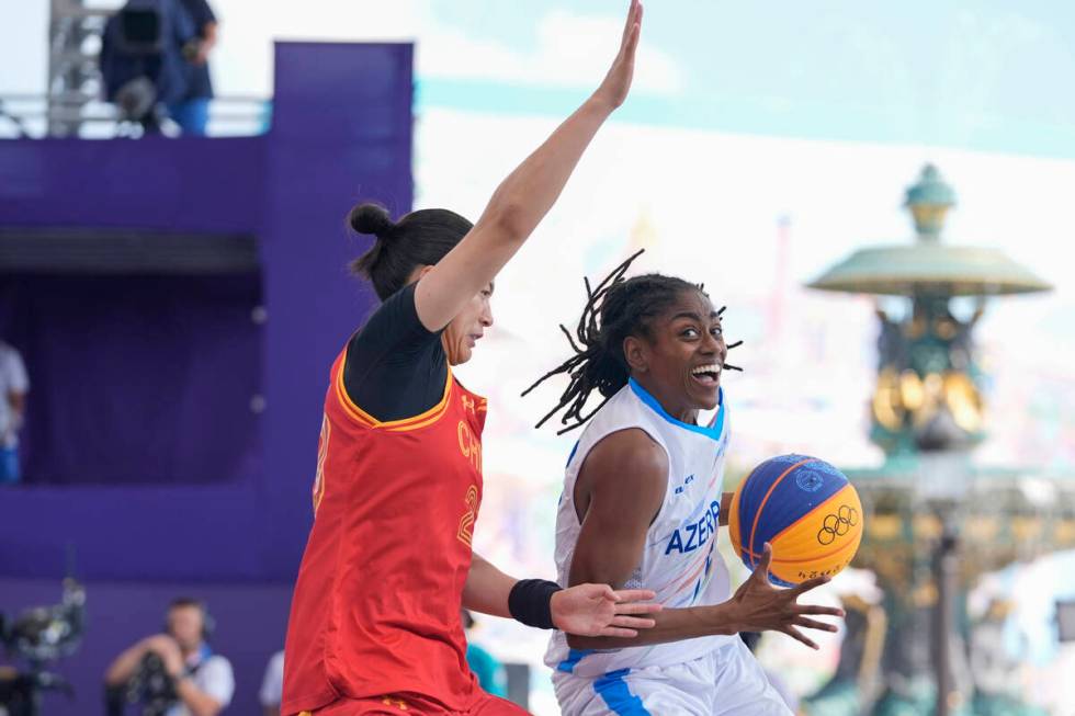 China's Wang Lili, left, defends Azerbaijan's Tiffany Hayes in the women's 3x3 basketball pool ...