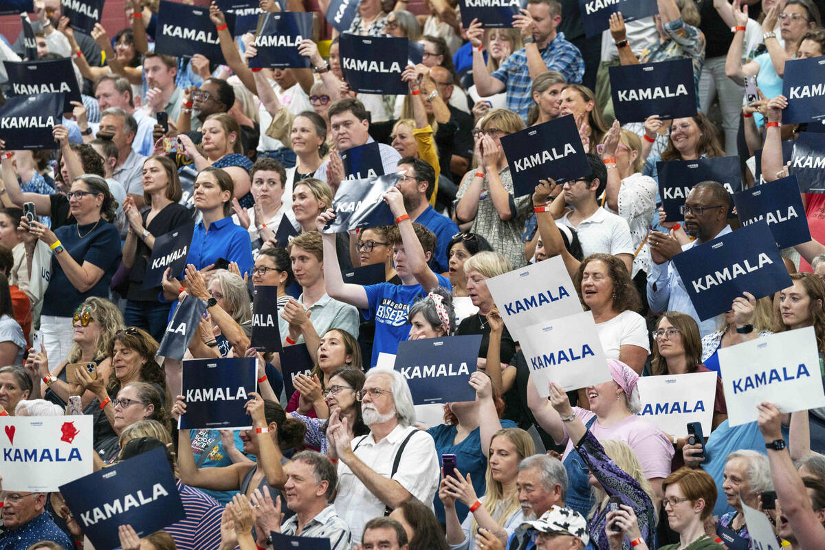 Supports hold up signs in support of Vice President Kamala Harris at an event, July 23, 2024, i ...