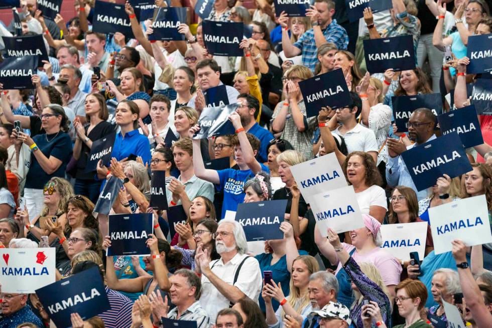 Supports hold up signs in support of Vice President Kamala Harris at an event, July 23, 2024, i ...