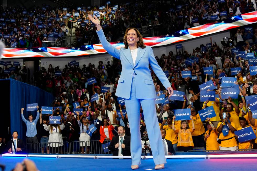 Vice President Kamala Harris waves during a campaign rally, July 30, 2024, in Atlanta. (AP Phot ...