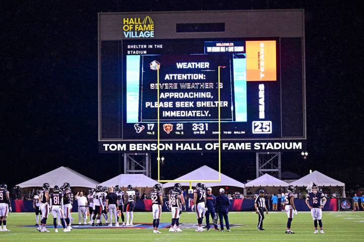 The Chicago Bears and the Houston Texans stand on the field as a delay is called during the sec ...