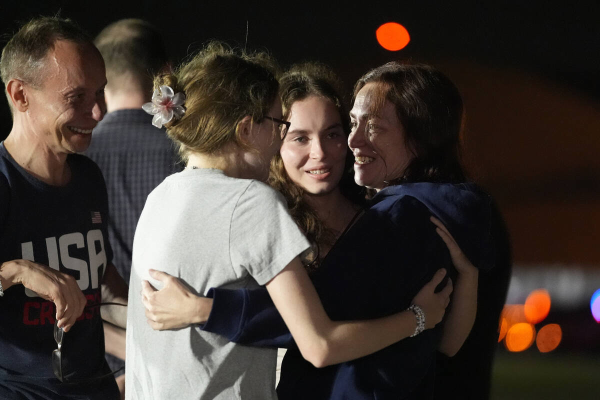 Alsu Kurmasheva, from right, hugs her daughters Bibi Butorin and Miriam Butorin as her husband ...