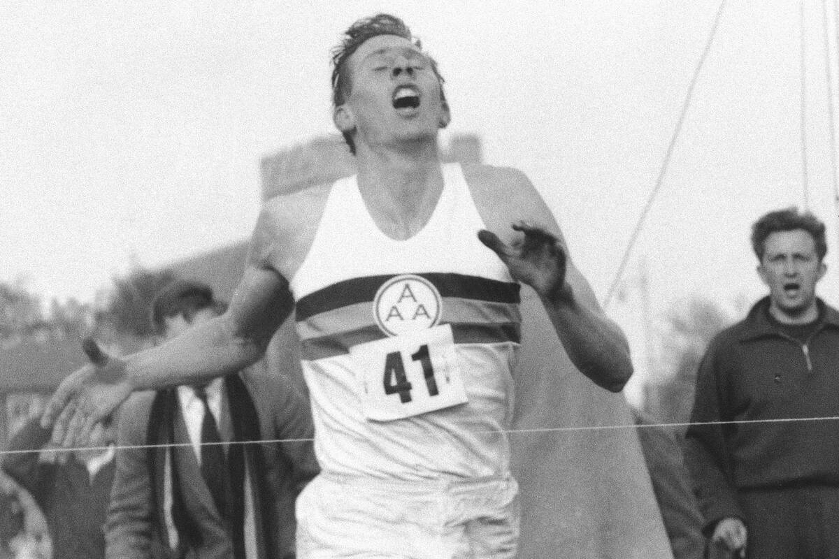 FILE - In this May 6, 1954, file photo, Britain's Roger Bannister hits the tape to break the fo ...