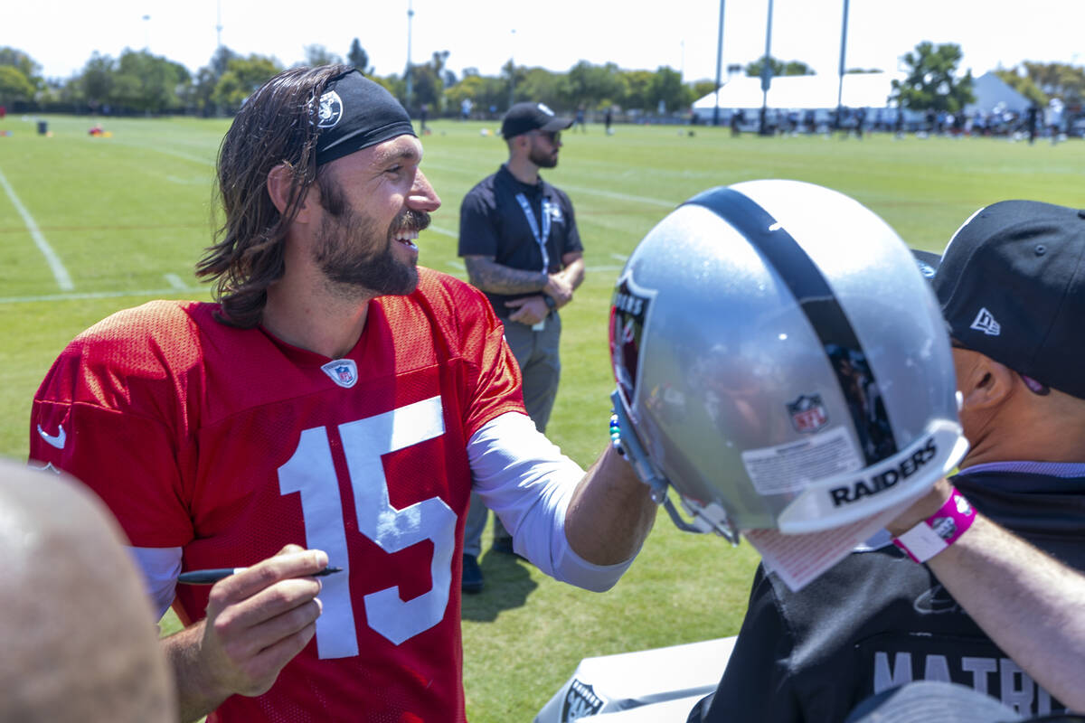 Raiders quarterback Gardner Minshew (15) signs autographs for fans following the third day of t ...