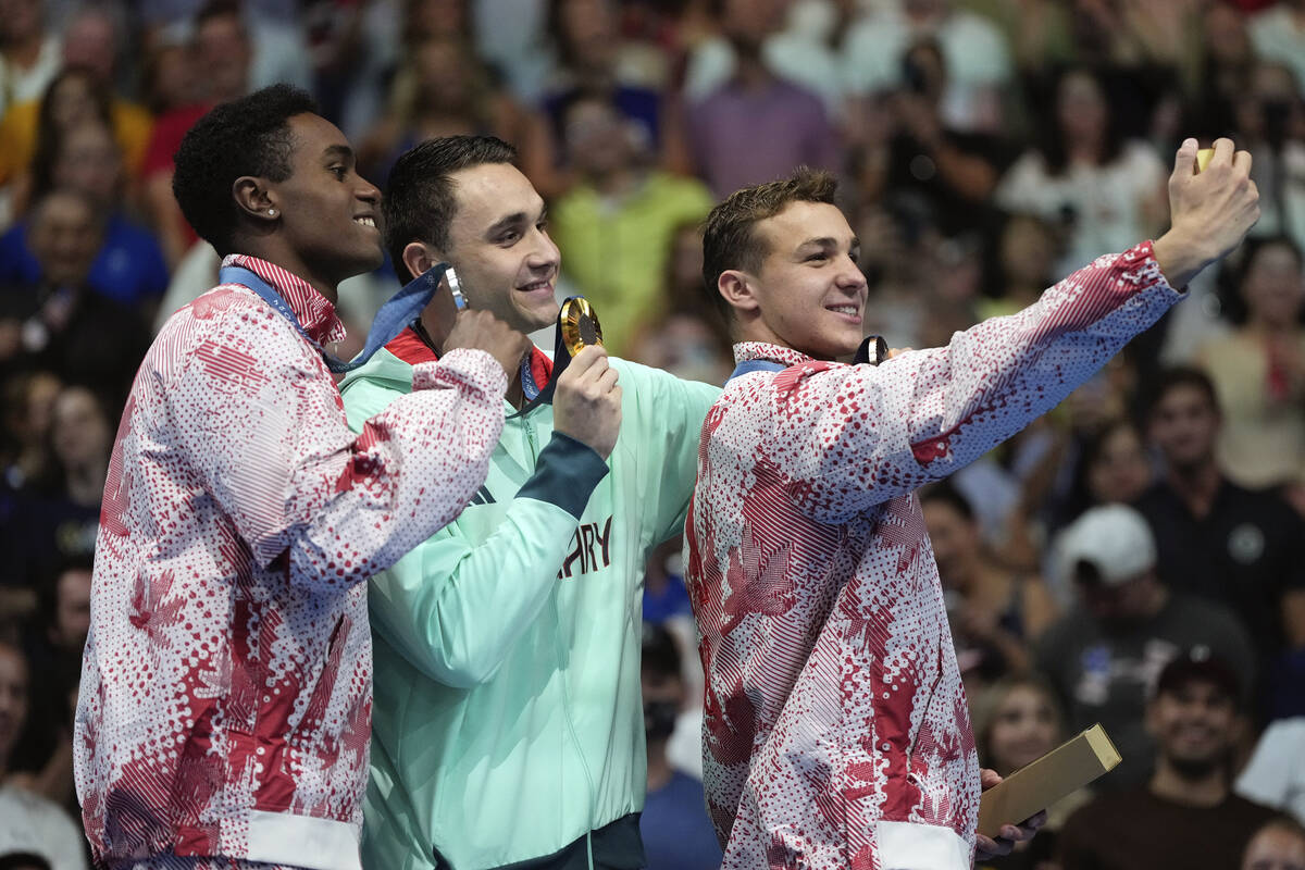 Canada's Josh Liendo, Hungary's Kristof Milak and Canada's Ilya Kharun pose with their medals o ...