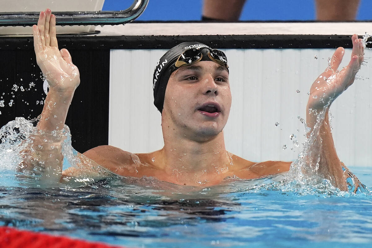 Canada's Ilya Kharun celebrates winning the bronze medal in the men's 100-meter butterfly final ...