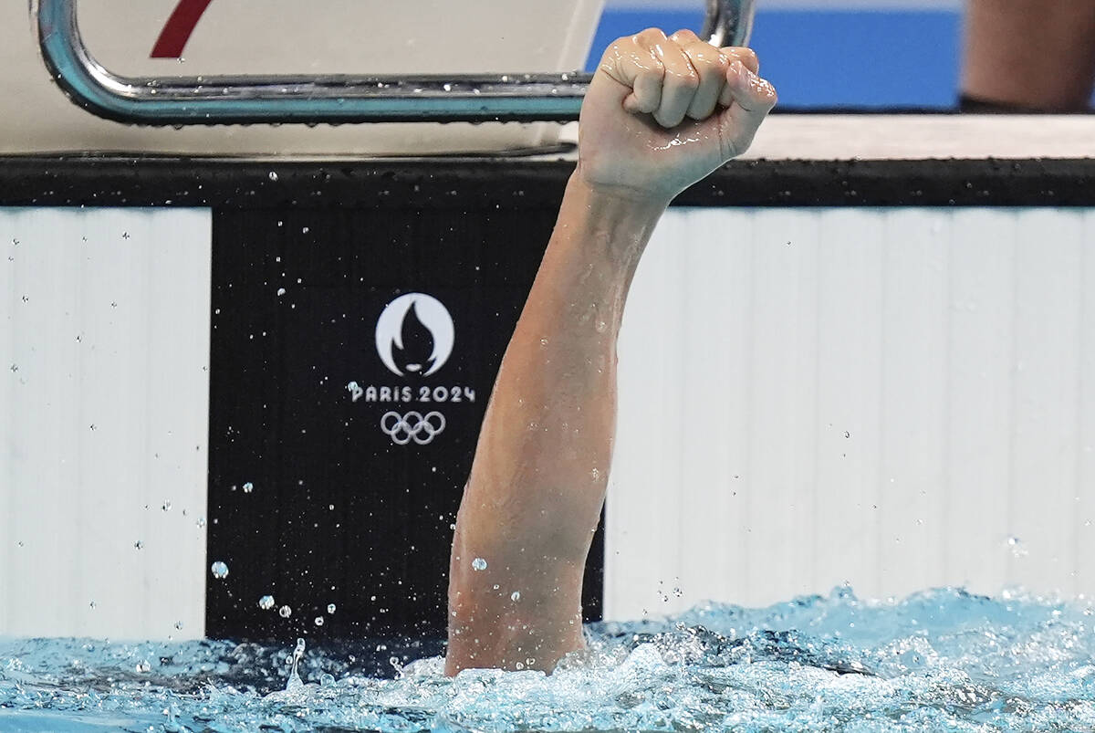 Canada's Ilya Kharun celebrates winning the bronze medal in the men's 100-meter butterfly final ...