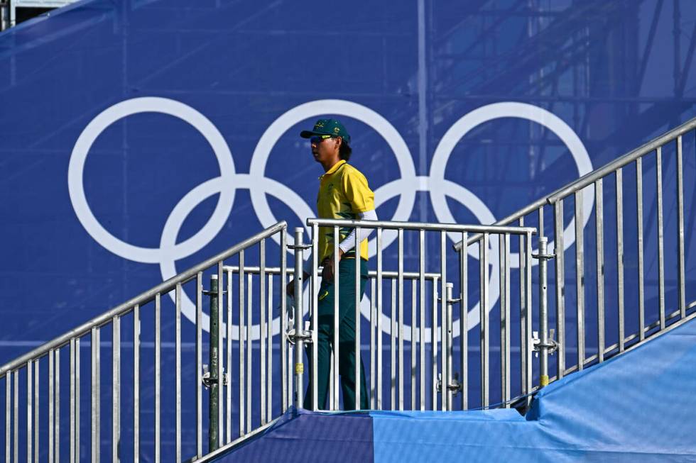 Min Woo Lee of Team Australia walks to the first tee during the first round of the 2024 Paris O ...