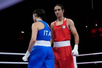 Algeria's Imane Khelif, right, walks beside Italy's Angela Carini after their women's 66kg prel ...